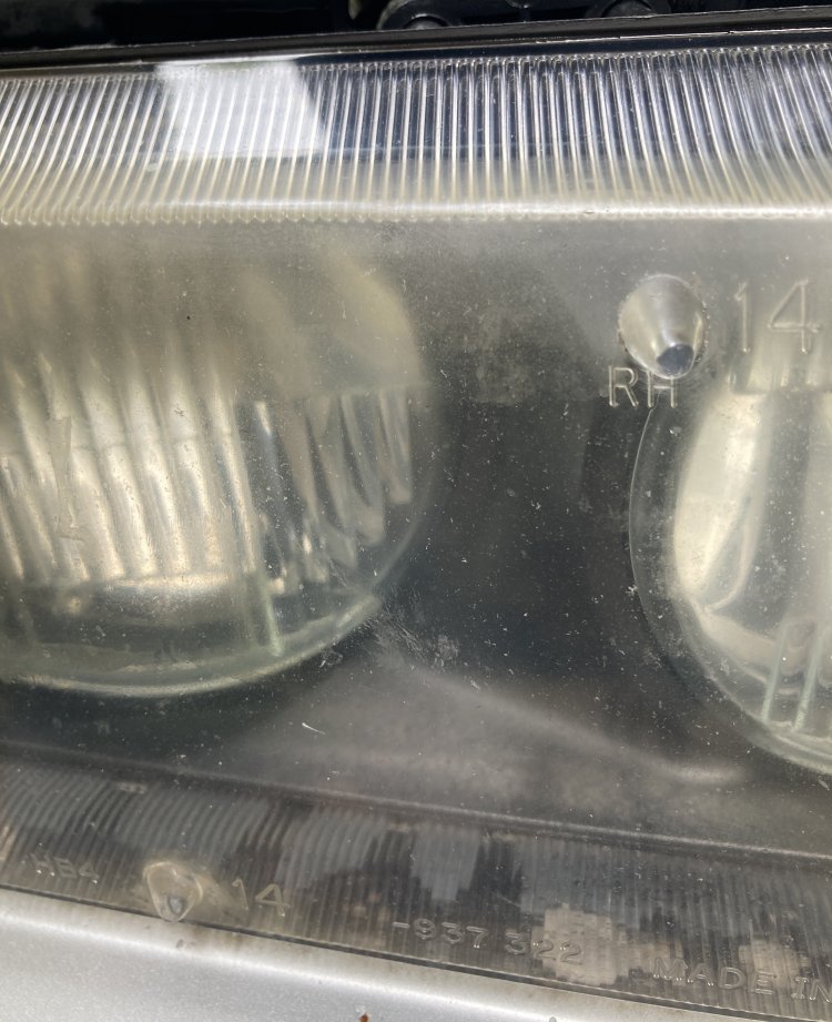 A closeup of my passenger headlight, showing excessive cloudiness and yellowing across the top of the housing