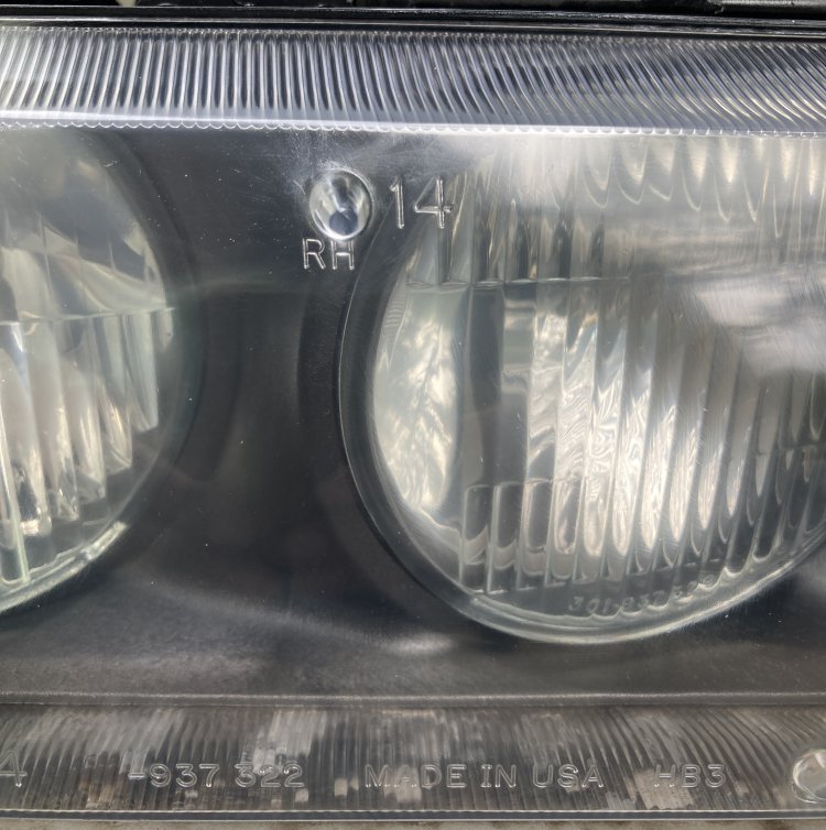 A closeup of my headlight after buffing; there's still some cloudiness around the top of the housing but is generally much improved