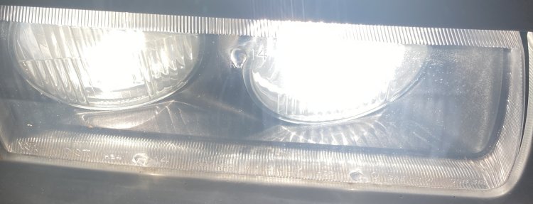 A shot of my passenger headlight from above after restoration with low and high beams engaged; there is much less light reflected by the housing