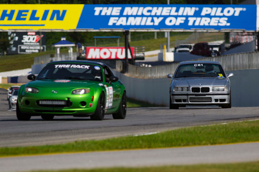 A photo of me setting up for turn 1 behind a Miata; I was only a little bit slower which I will feel proud about even though the Miata had much less power