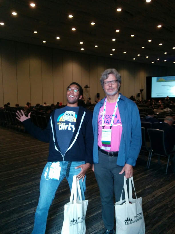 A picture with me and Guido van Rossum; I got a picture with him before a coworker but he uploaded his to the company slack first for all the clout.