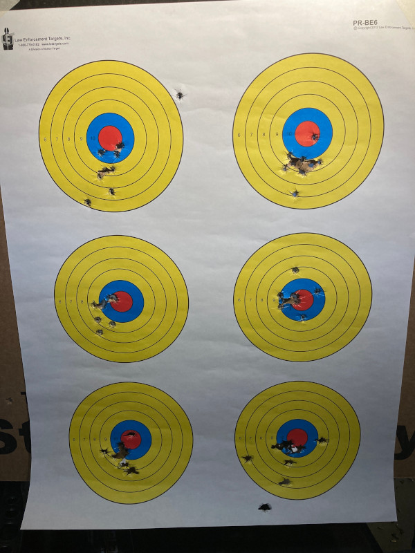 A set of targets shot with varying guns, left side for warming up and right side for trying; from the top were Glock 19, Canik of unknown model, S&W Shield EZ